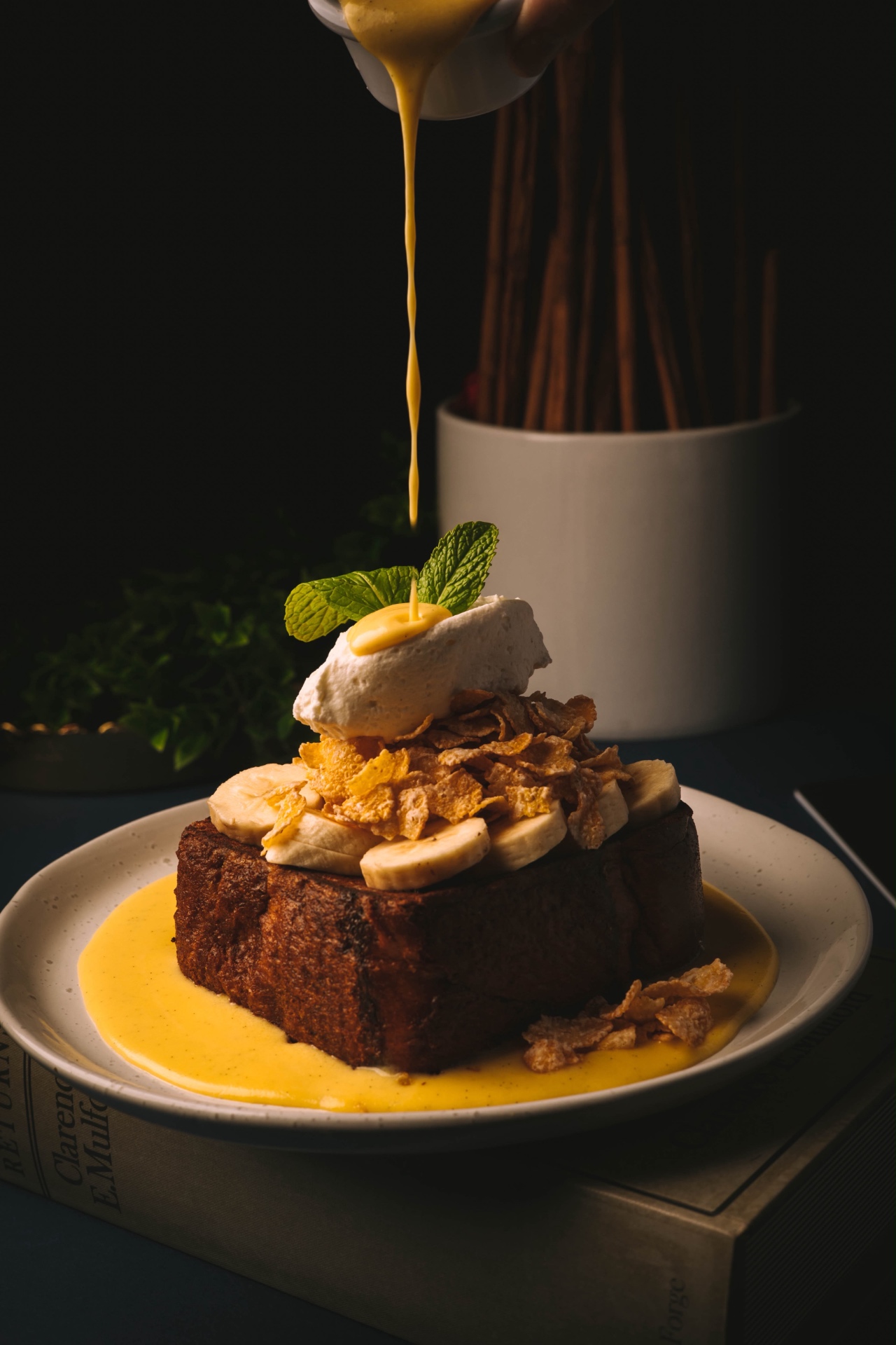 Brioche dessert with banana, cream and warm sauce