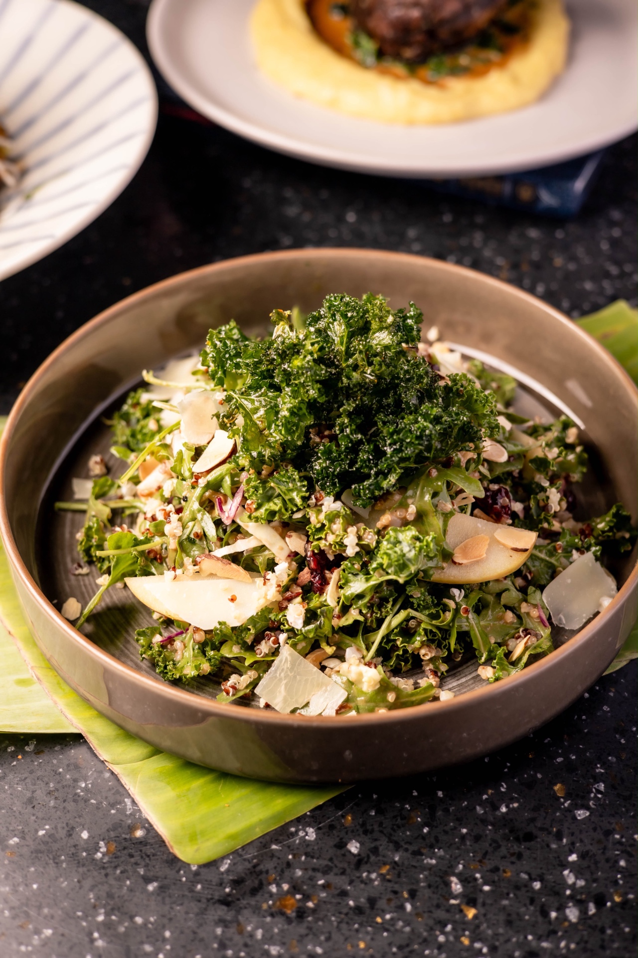 Kale and quinoa salad with almonds and shaved cheese