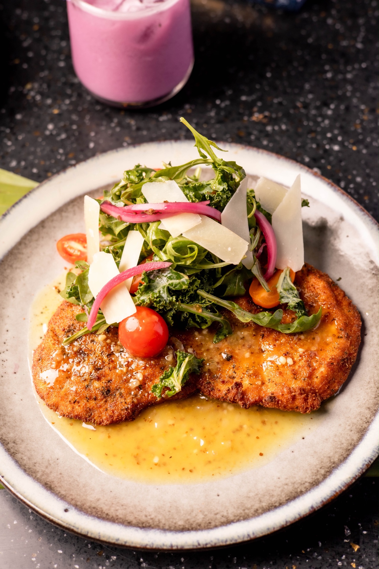 Golden cutlet with greens, tomatoes and shaved cheese